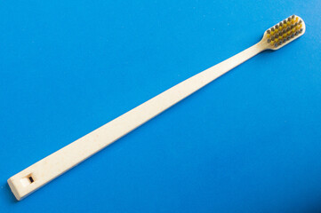 White toothbrush on blue background. Medical dentist tool. Healthcare concept.