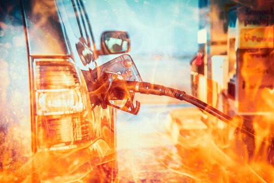 pumping gasoline fuel in a car at a gas station. Fire effect.