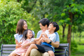Happy Asian family parent and little kids enjoy and fun outdoor lifestyle on summer holiday...
