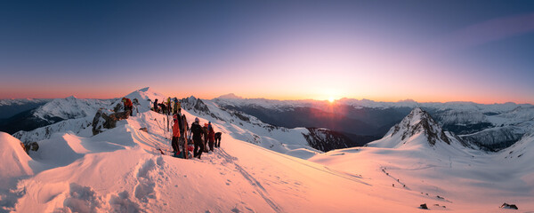 people hiking in winter, ski touring, ski, celebrating at the summit, sunrise time, snow