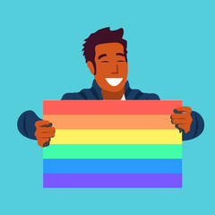 Happy man holding gay pride rainbow flag for Pride Month concept.