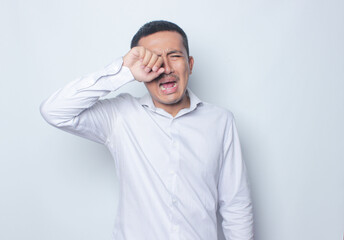 Crying expression asian young man in white shirt  isolated on white background.
