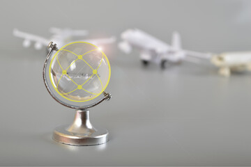 Airplane and crystal globe on grey background. Travel concept. Booking service or travel agency sign. Air transportation.