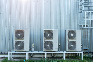Condenser unit or compressor on roof of industrial plant building with building wall background....