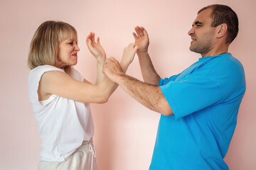 a man and a woman with facial expressions from pain on their faces do psychological training rubber bands on each other's wrist, Psychological techniques and exercises