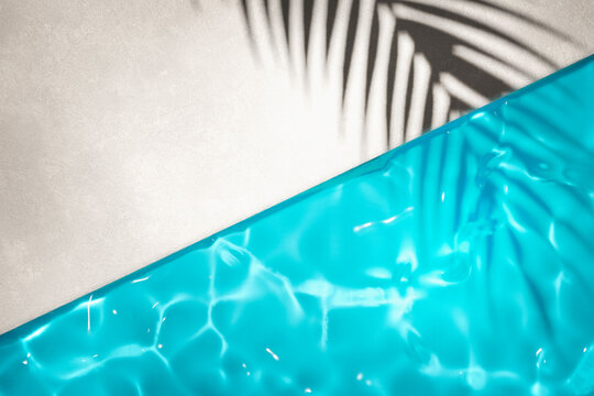 Luxury swimming pool and palm shadow in water top view. Summer tropical background for product placement podium mockup.