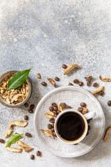 Fototapeta na wymiar Healthy organic energizing adaptogen, trendy drink. Mushroom coffee in a cup with coffee beans. View from above. Copy space.
