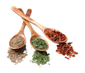 Wooden spoons with different spices on white background