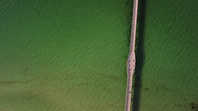 Birds view, shot by a drone, showing the green water and the boat dock of the seaside resort Binz, located on the Ruegen Island in Germany