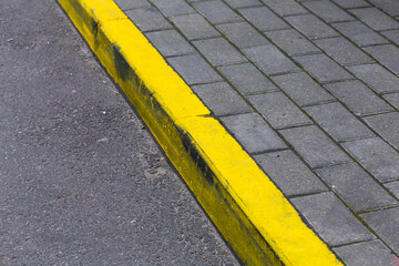 Yellow curb line on the road
