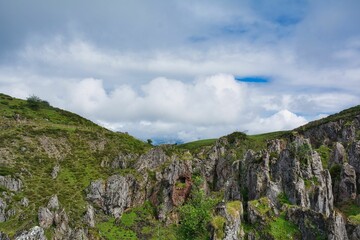 Fototapeta premium Beautiful landscape of green rocks on a cloudy day
