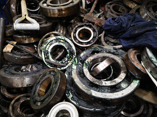 Obraz na płótnie Canvas Grease bearings removed from electric motors and gearboxes piled together.