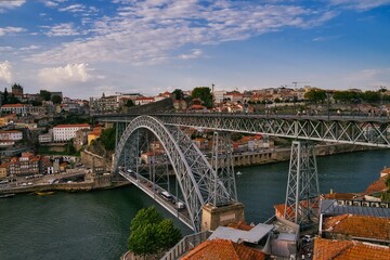 Low-angle shot of a beautiful bridge above the water in Oporto, Portugal