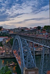 Vertical shot of a beautiful bridge above the water in Oporto, Portugal