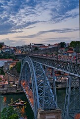 Fototapeta premium Vertical shot of a beautiful bridge above the water in Oporto, Portugal