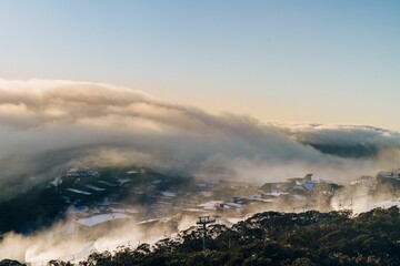 Fototapeta premium Scenic shot of a village with small houses covered in clouds