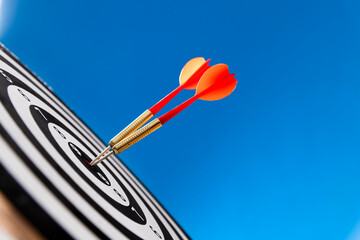 Two darts hitting on center target
