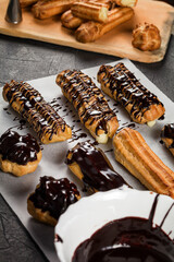 Chocolate is used by the pastry chef to decorate ready-made eclairs