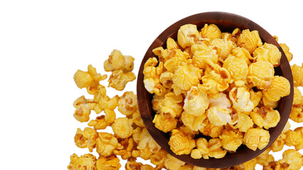 Caramelized popcorn in a wooden cup on white background (top- down-shot)