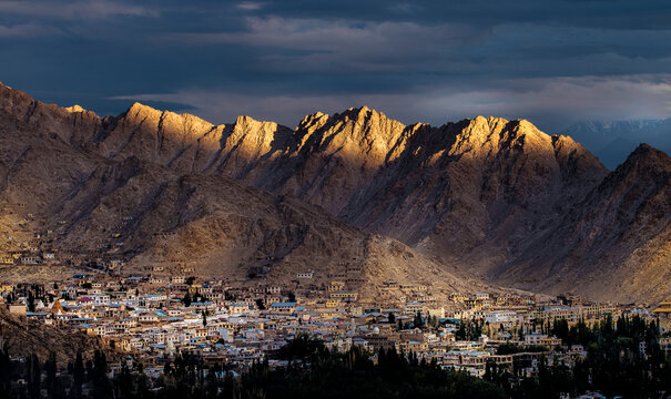 sunset in the Leh Town with mountains in the background.