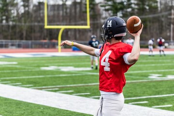 Young football player throwing a ball