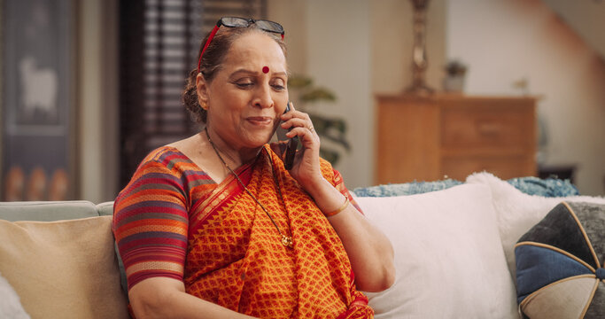 Elderly Indian Woman Using Smartphone, Calling Her Friends. Joyful Smiling Senior Lady Talking to Her Family, Daughter, Son, Relatives, Grandchildren. Medium Close-up 