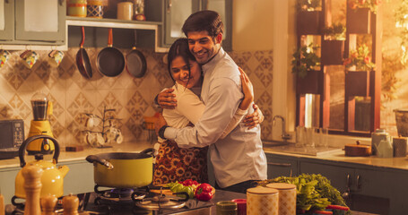 Indian Girl Preparing Food: Magnificent Young Woman Preparing Delicious Home Cooked Traditional Meal, Beloved Boyfriend Embraces Her Lovingly. Celebrating Traditional Culture.Mid Portrait