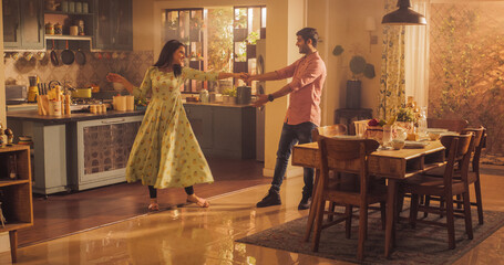 Young Couple Dancing and Having Fun in the Kitchen. Boyfriend and Girlfriend Sharing Moment of Love...