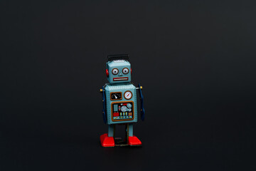 Retro robot toy on black background