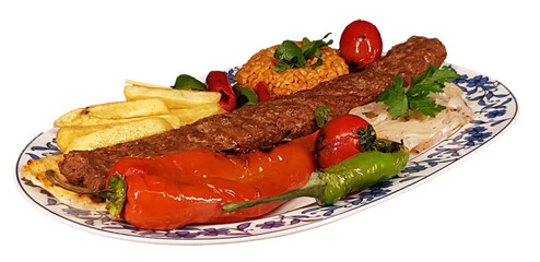 isolated turkish flavor adana, urfa kebab served with onion, tomato, pepper and bulgur pilaf on a plate