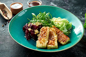 Salad with fried tofu and beets in a bowl. Superfood