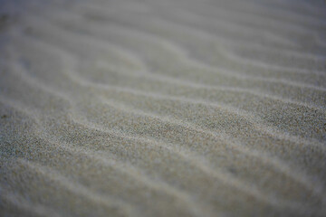 Fototapeta na wymiar Beautiful shot of white sand in waves - perfect for wallpapers