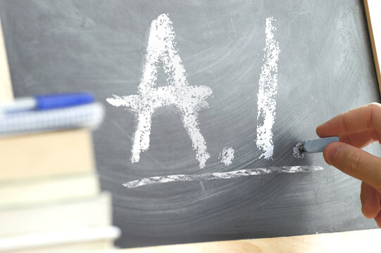 Blackboard with the letters AI wrote on it. Artificial Intelligence education in a classroom.