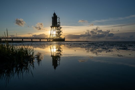 Silhouette of the historic lighthouse Obereversand in Am Kutterhafen, Wurster Nordseekuste, Germany