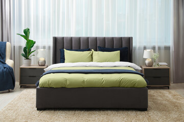 Stylish bedroom interior with large comfortable bed