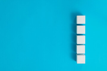 Wooden toy cubes on blue background