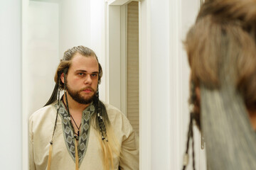A Viking man in front of the mirror