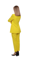 Businesswoman in suit standing on white background, back view