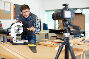 young male repairman recording video for his blog