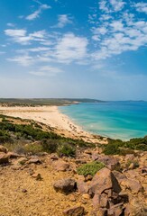 Vertical aerial view of a beautiful seashore with a rocky cliff in Kef Abbed, Tunisia