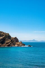 Vertical shot of a seascape with rocky cliffs on the coast of Korbous, Tunisia