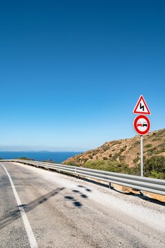 Vertical shot of a road with a sea and blue sky in the background in Korbous, Tunisia