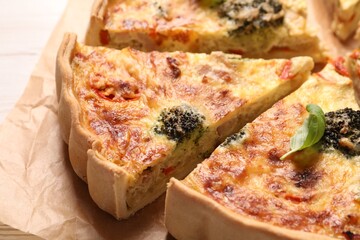 Delicious homemade vegetable quiche on parchment paper, closeup