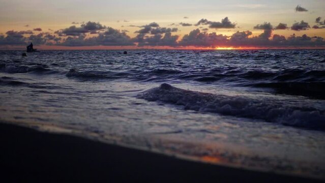 Slow motion of splashing waves on the Caribbean Sea in Santa Marta, Colombian at sunset