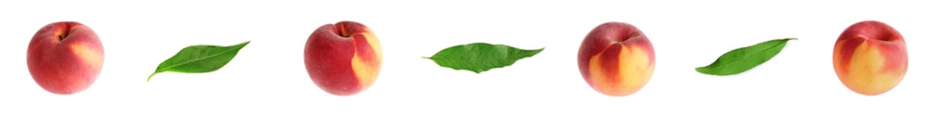 Fresh peaches and green leaves on white background