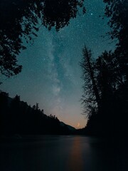 Vertical shot of the starry sky with the spooky crescent of the moon from Smokey Point, Washington