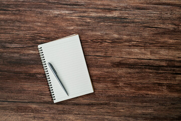 Blank notebook and a pen on the table