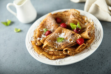 Traditional homemade crepes with raspberry