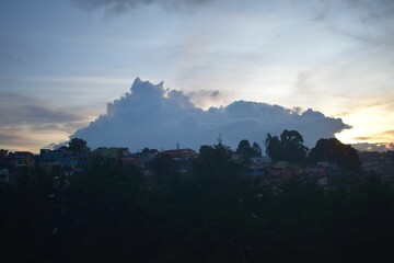 Clodscape over woody terrain at sunrise