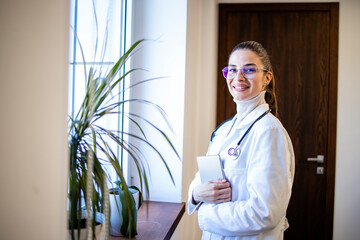 Portrait of female doctor with stethoscope standing in the hospital.